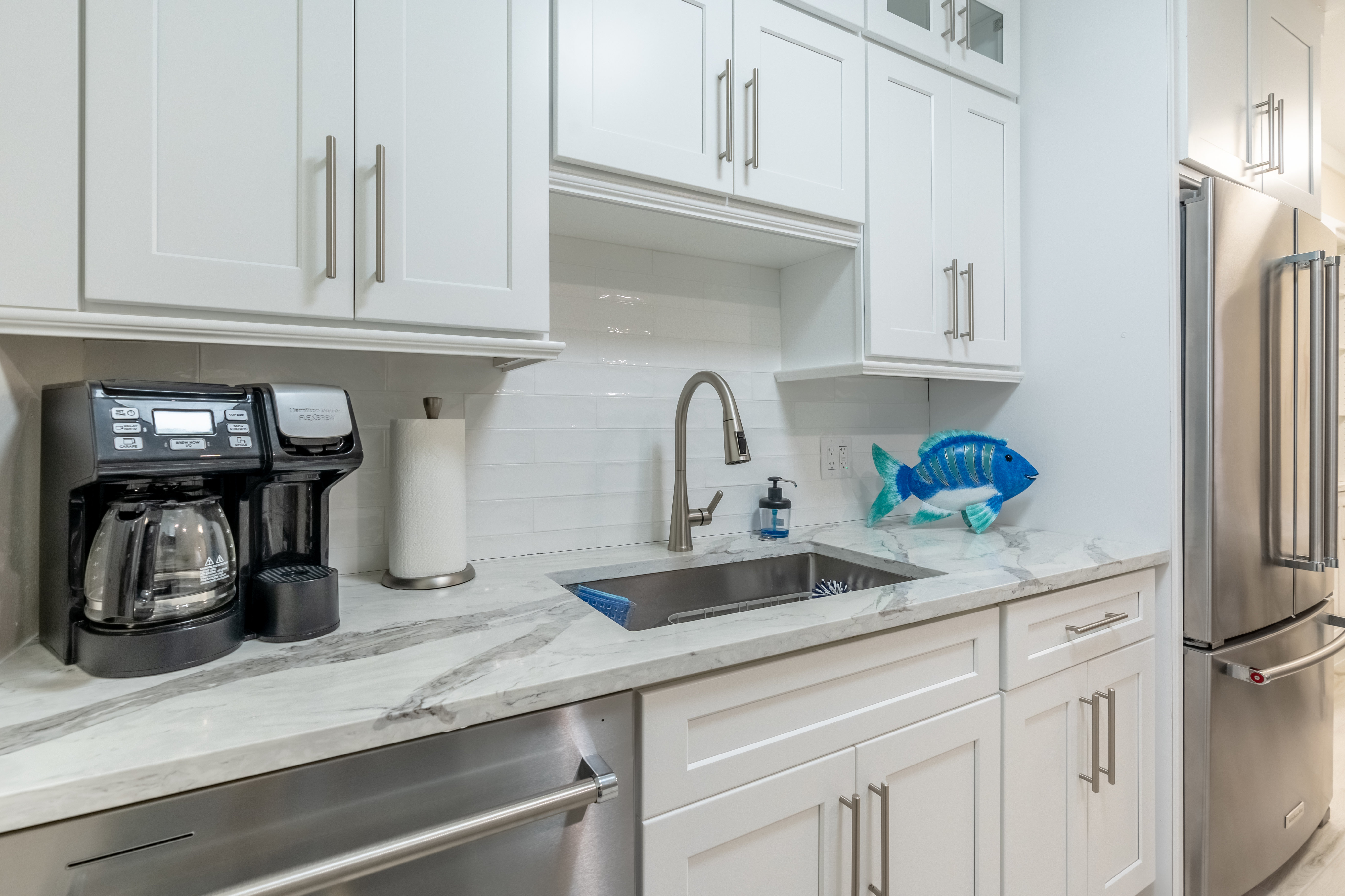 Stainless sink and marble counters in the kitchen