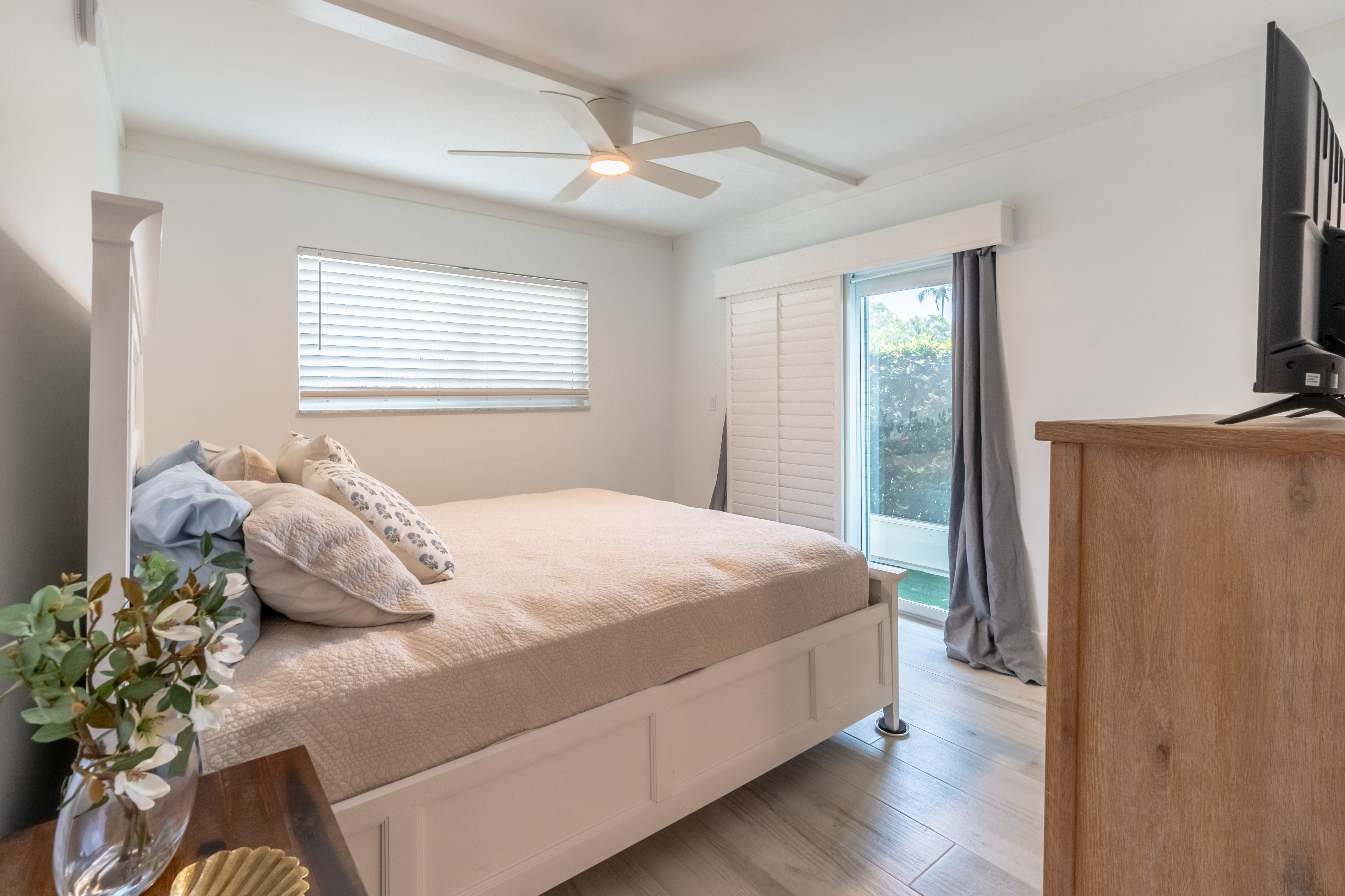 Light-filled primary bedroom with sliding door to the garden